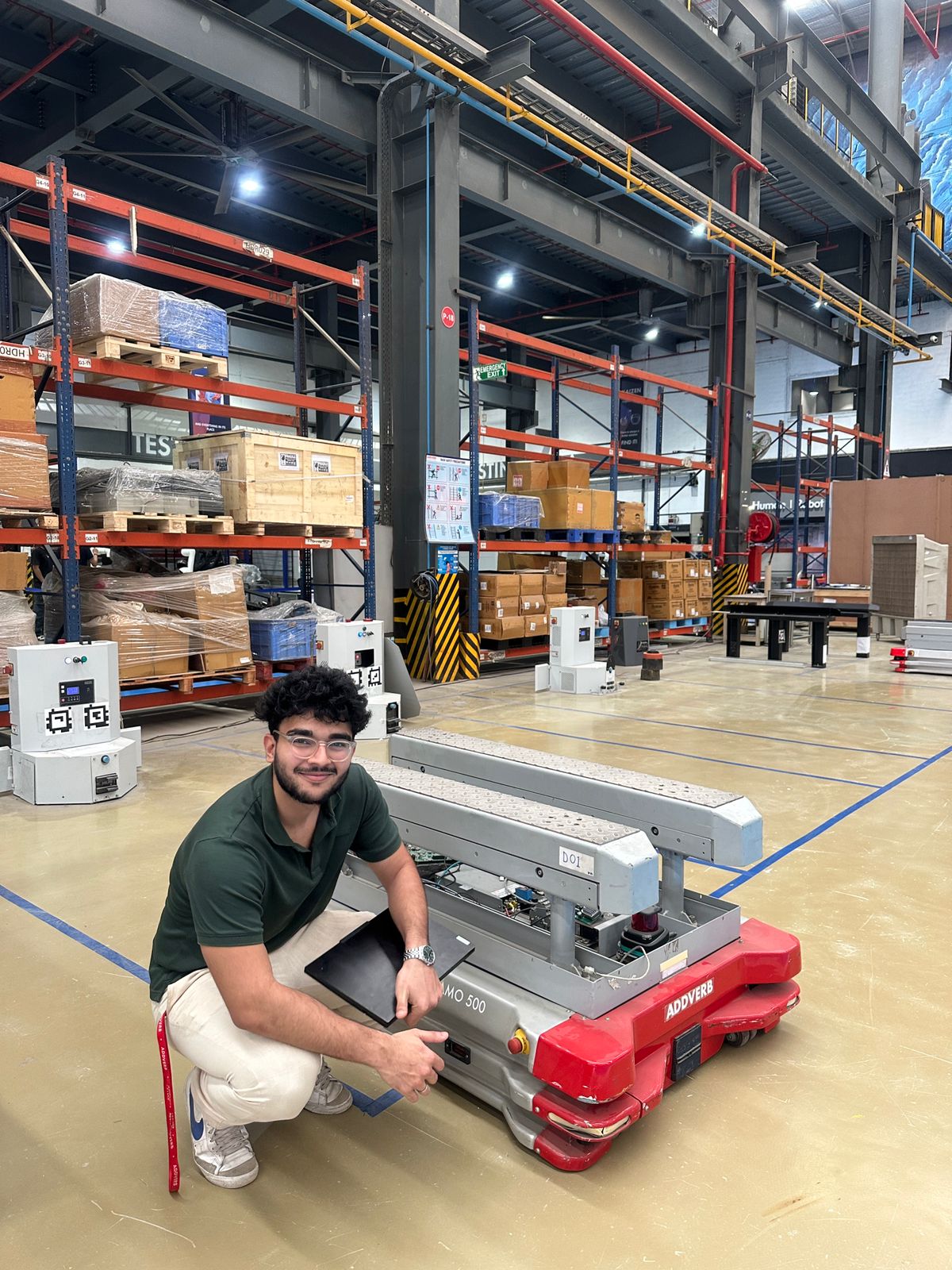 Sahil Nakhuda with industrial AMR in warehouse